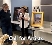 Photo of an artist at a public art open house discussing her painting of Deerfield Square.