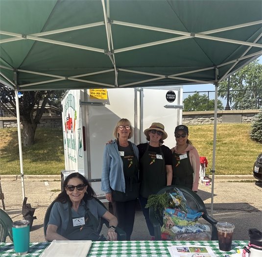 Market volunteers staffing the Information Booth