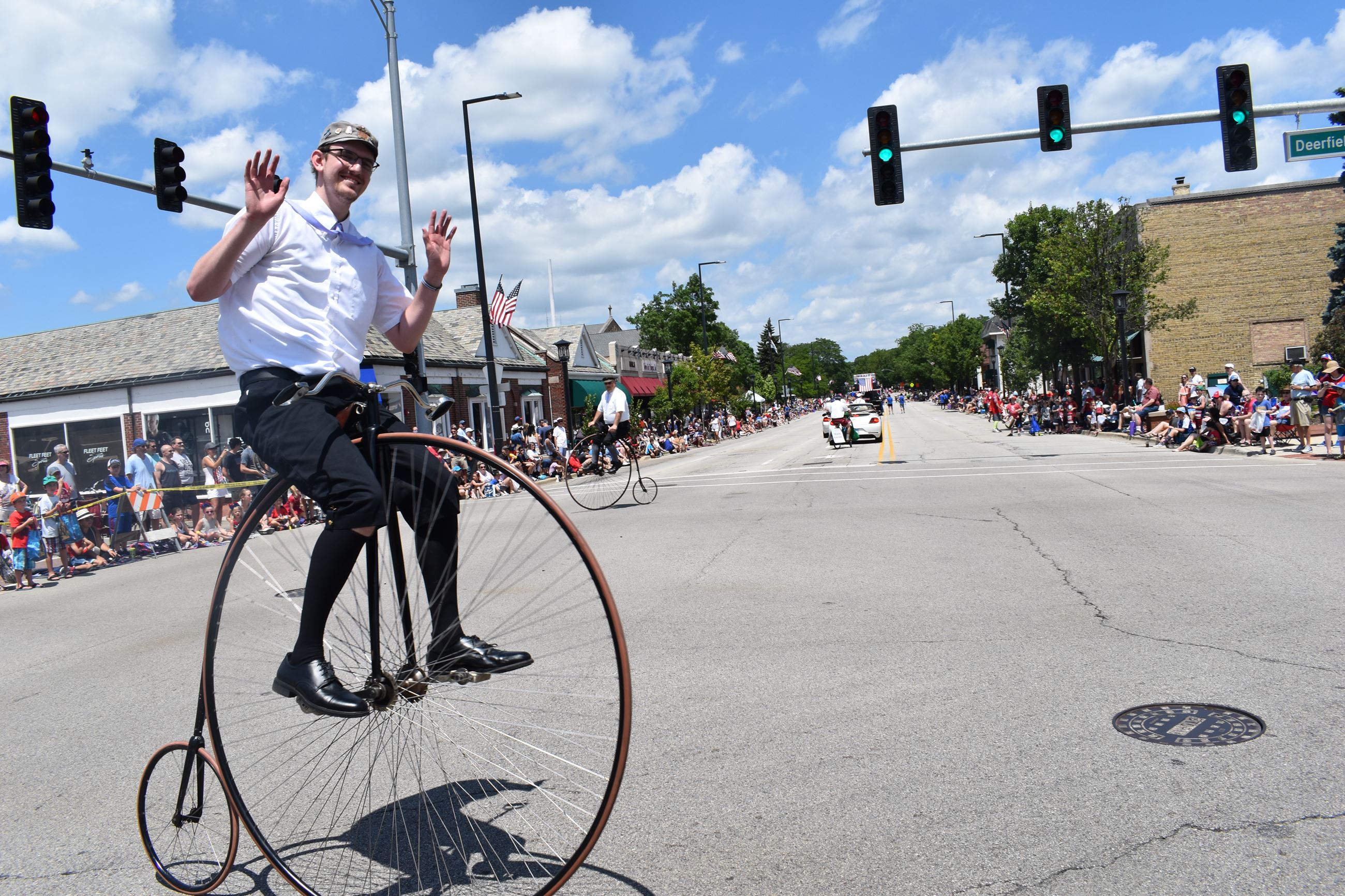 Man Riding Unicycle in Street Intersection during Parade